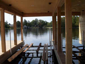 Photograph of a beautiful boat lift built by Vines Piers, Inc., on a beautiful Louisiana bayou 